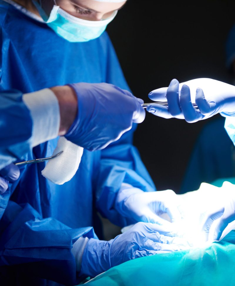 Surgeons passing scissors to each other